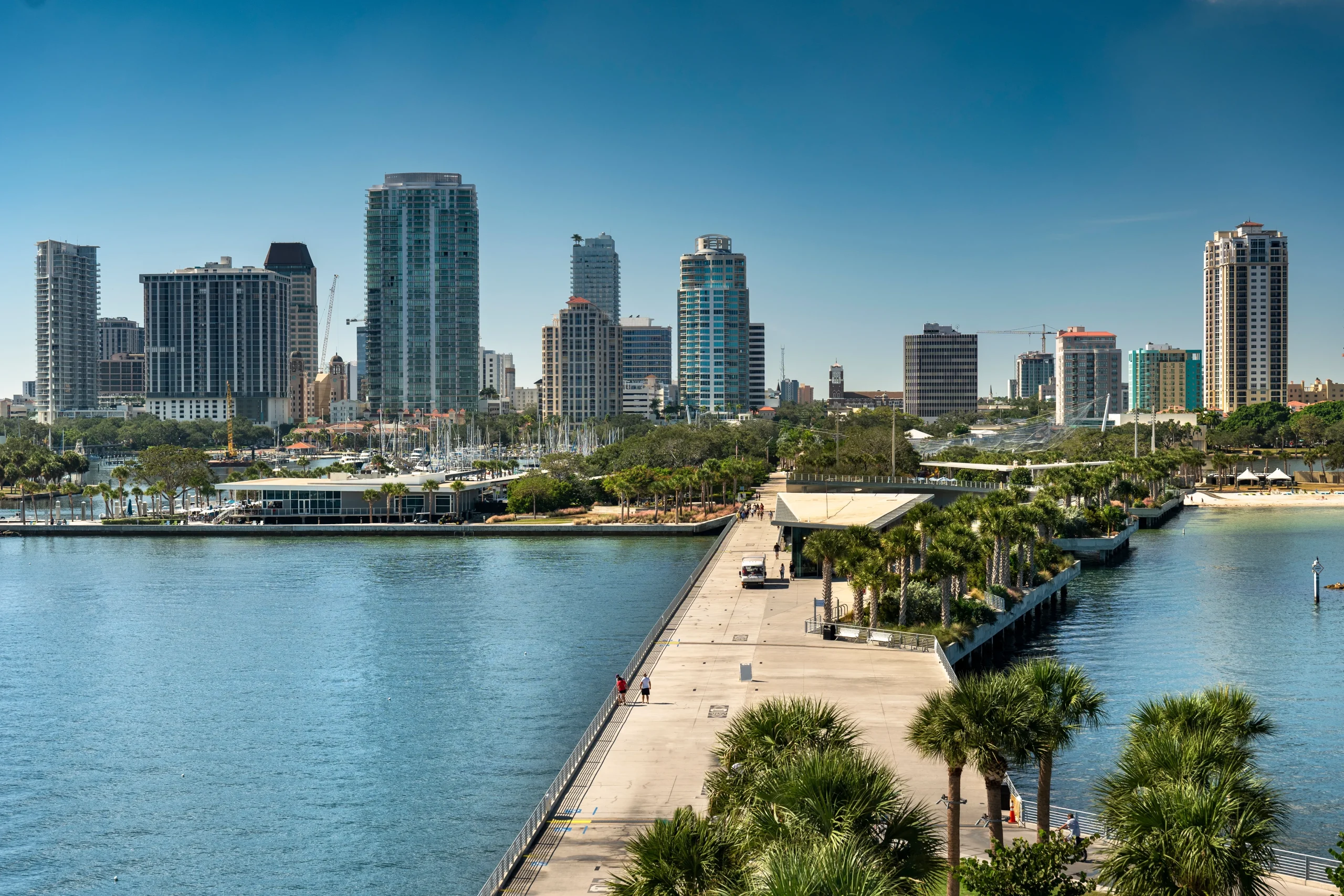 St. Pete Pier walkway with downtown St. Petersburg Florida skyline and waterfront marina in the background
